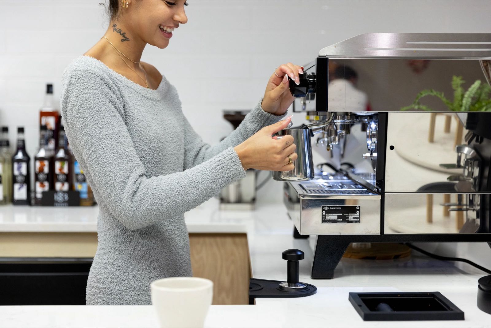 A Sobar barista preparing a coffee at the espresso machine
